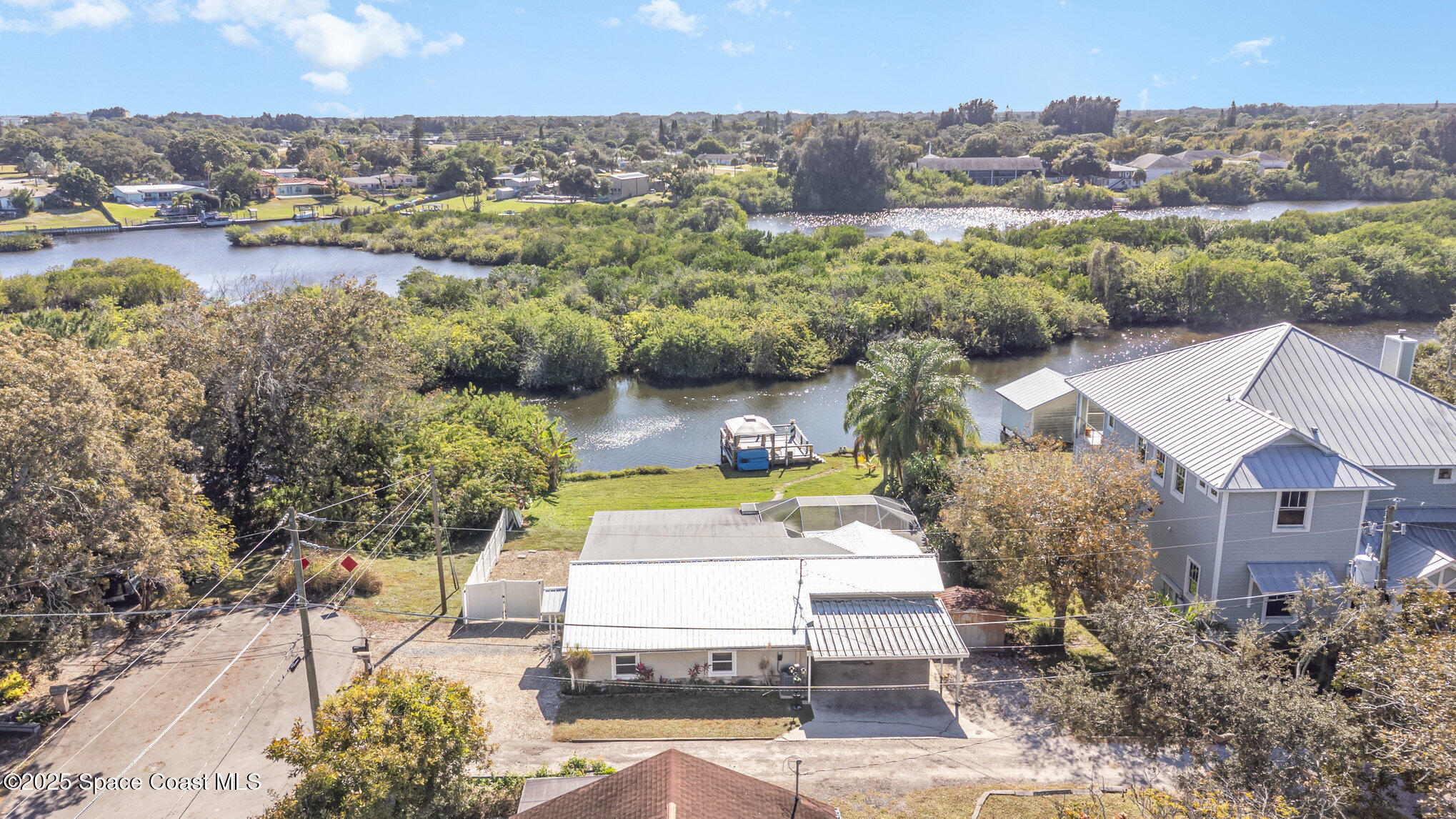 1304 Lichty Street Palm Bay, FL 32905 - Photo 46 of 63 an aerial view of a house with a yard and lake view
