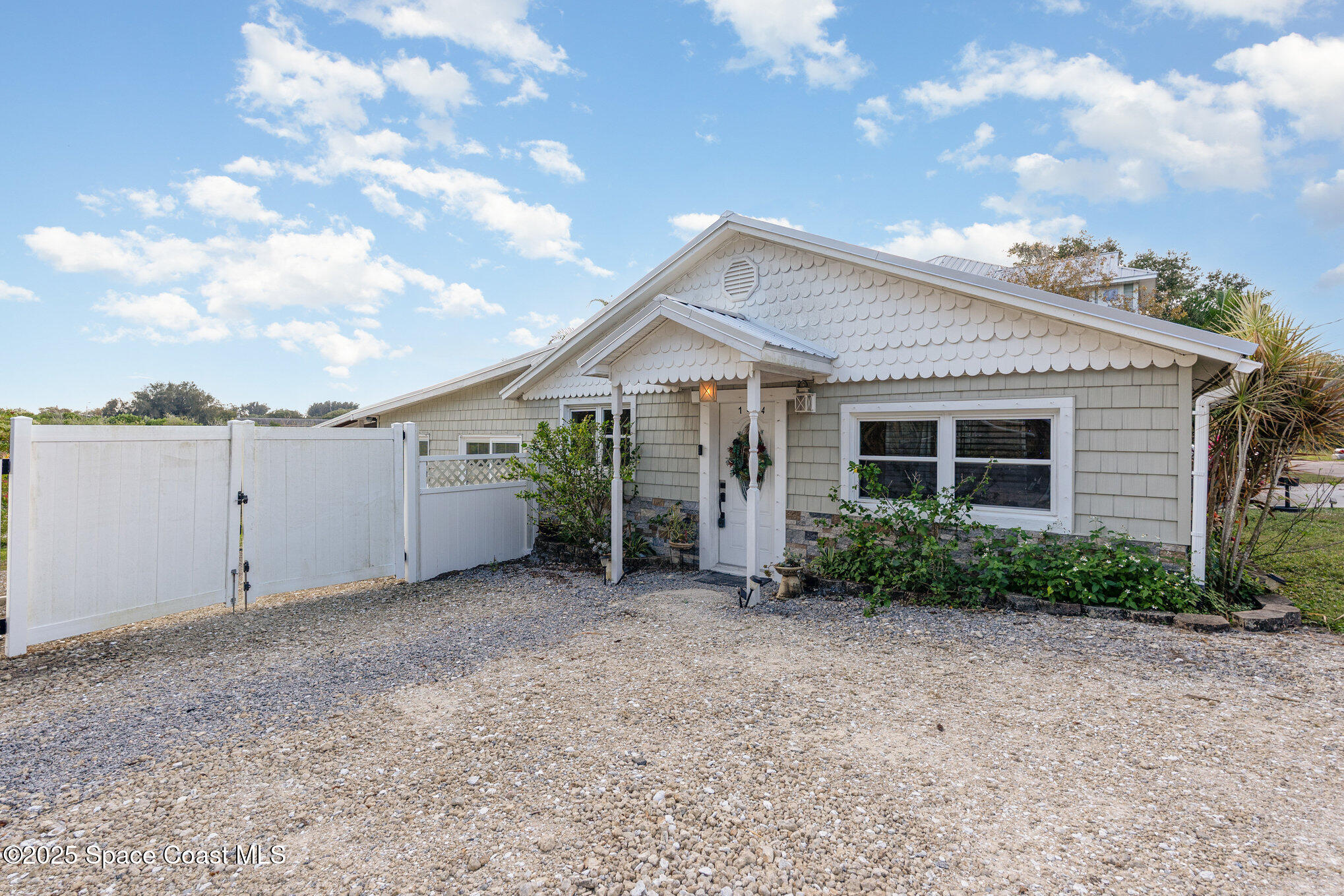 1304 Lichty Street Palm Bay, FL 32905 - Photo 5 of 63 a view of a house with potted plants and a large window