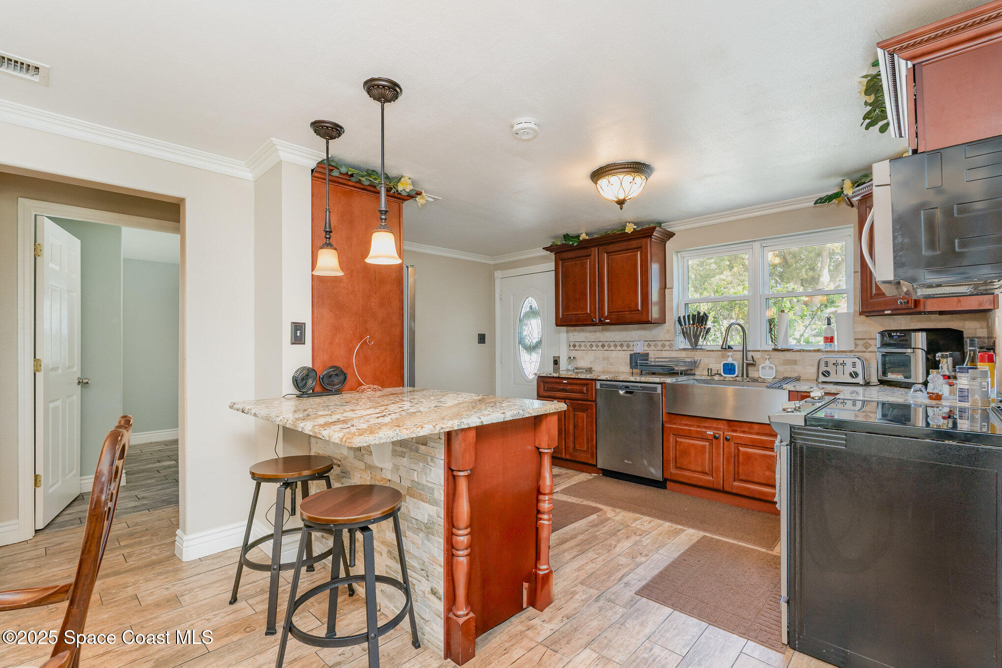 1304 Lichty Street Palm Bay, FL 32905 - Photo 10 of 63 a kitchen with stainless steel appliances granite countertop a stove top oven a sink a dining table and chairs