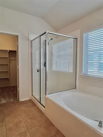 a bathroom with a bathtub and a shower