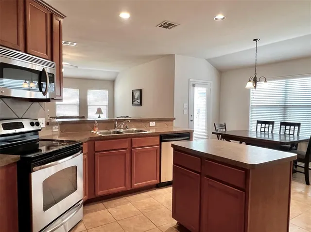 a kitchen with granite countertop a sink and cabinets