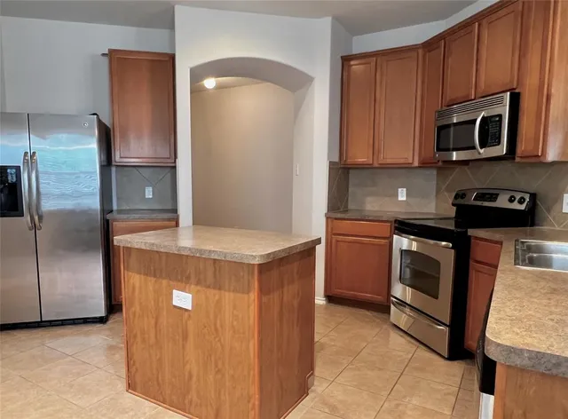 a kitchen with a refrigerator sink and microwave