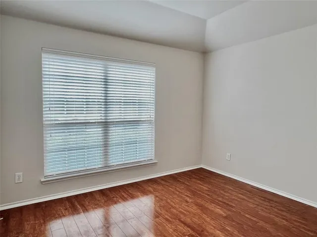 an empty room with wooden floor