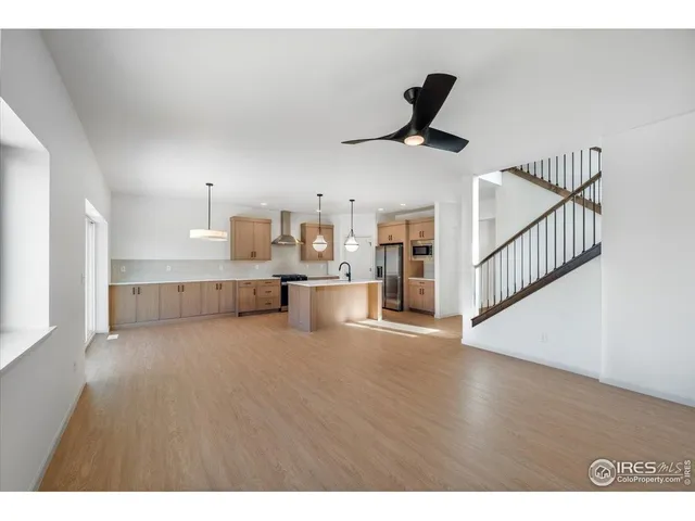 a view of a kitchen with furniture and a ceiling fan