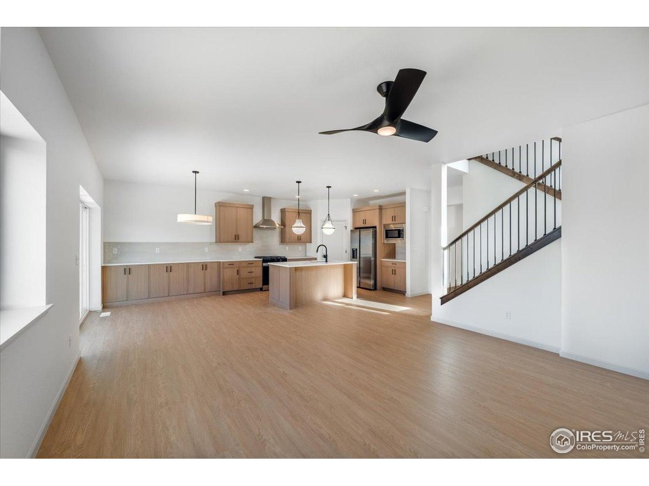 825 Doubleleaf Drive Windsor, CO 80550 - Photo 11 of 25 a view of a kitchen with furniture and a ceiling fan