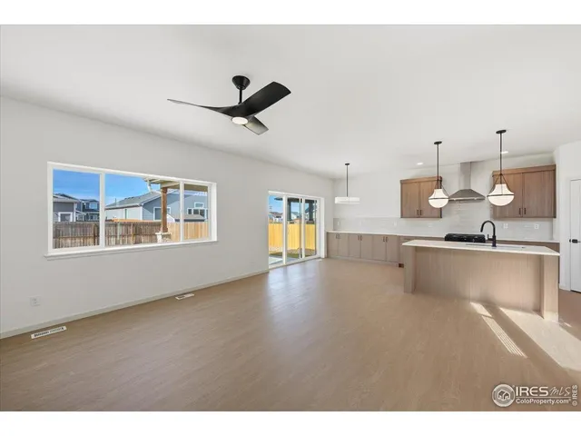 a view of a kitchen with a sink hardwood floor and a window