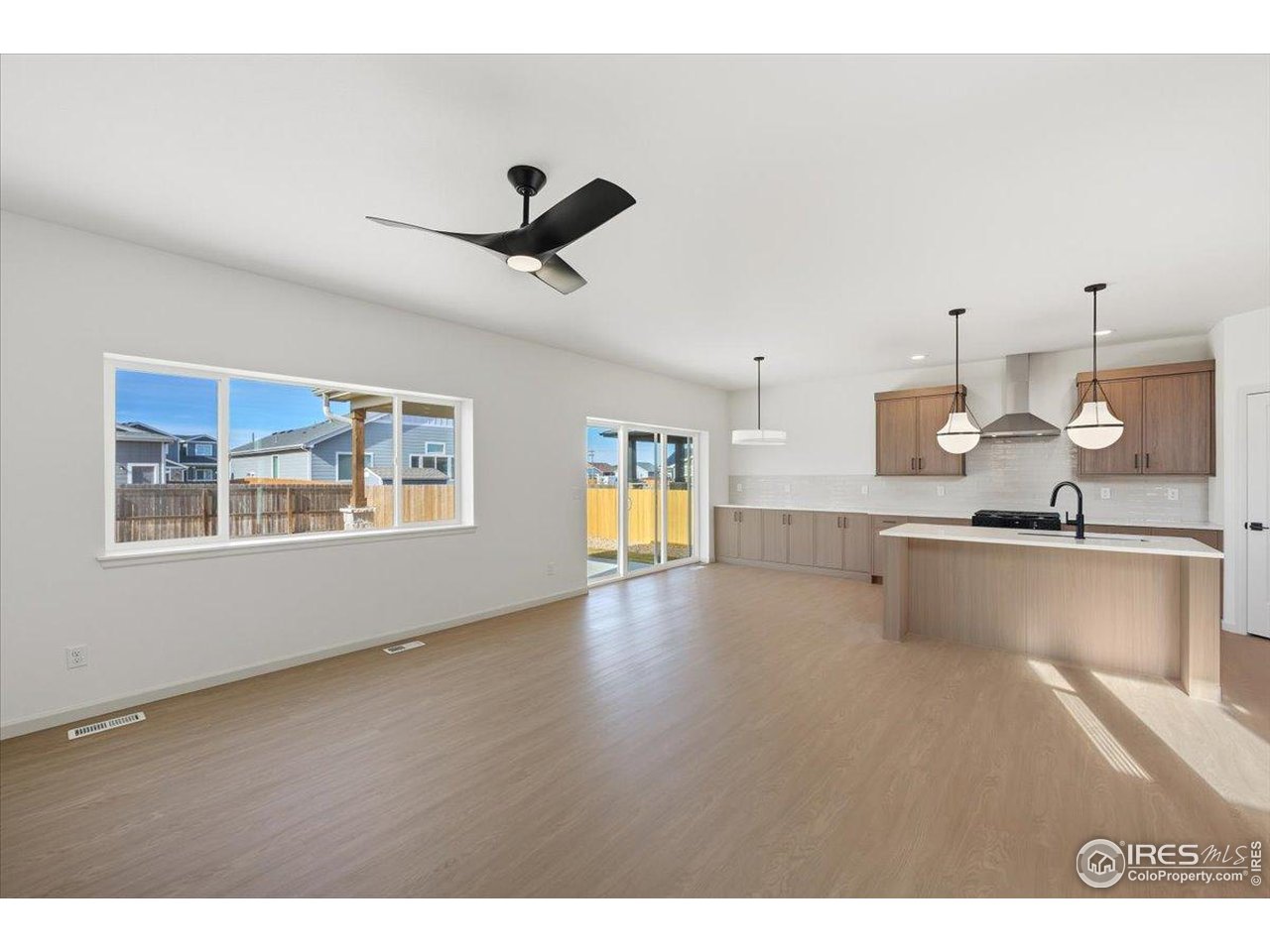 825 Doubleleaf Drive Windsor, CO 80550 - Photo 12 of 25 a view of a kitchen with a sink hardwood floor and a window