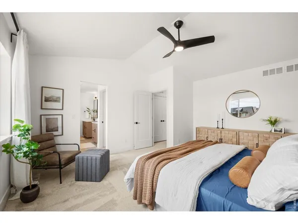 a bedroom with a bed couch and a window