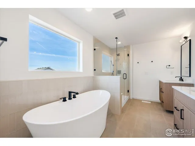 a bathroom with a double vanity sink mirror and shower