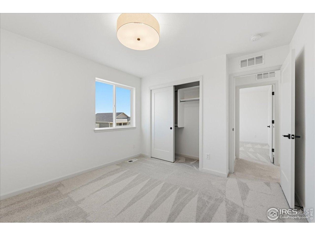 825 Doubleleaf Drive Windsor, CO 80550 - Photo 18 of 25 a view of an empty room and window