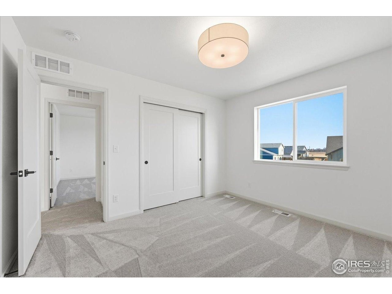 825 Doubleleaf Drive Windsor, CO 80550 - Photo 20 of 25 a view of an empty room with a window