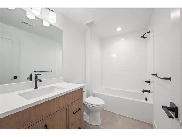 a bathroom with a sink a toilet and a bathtub