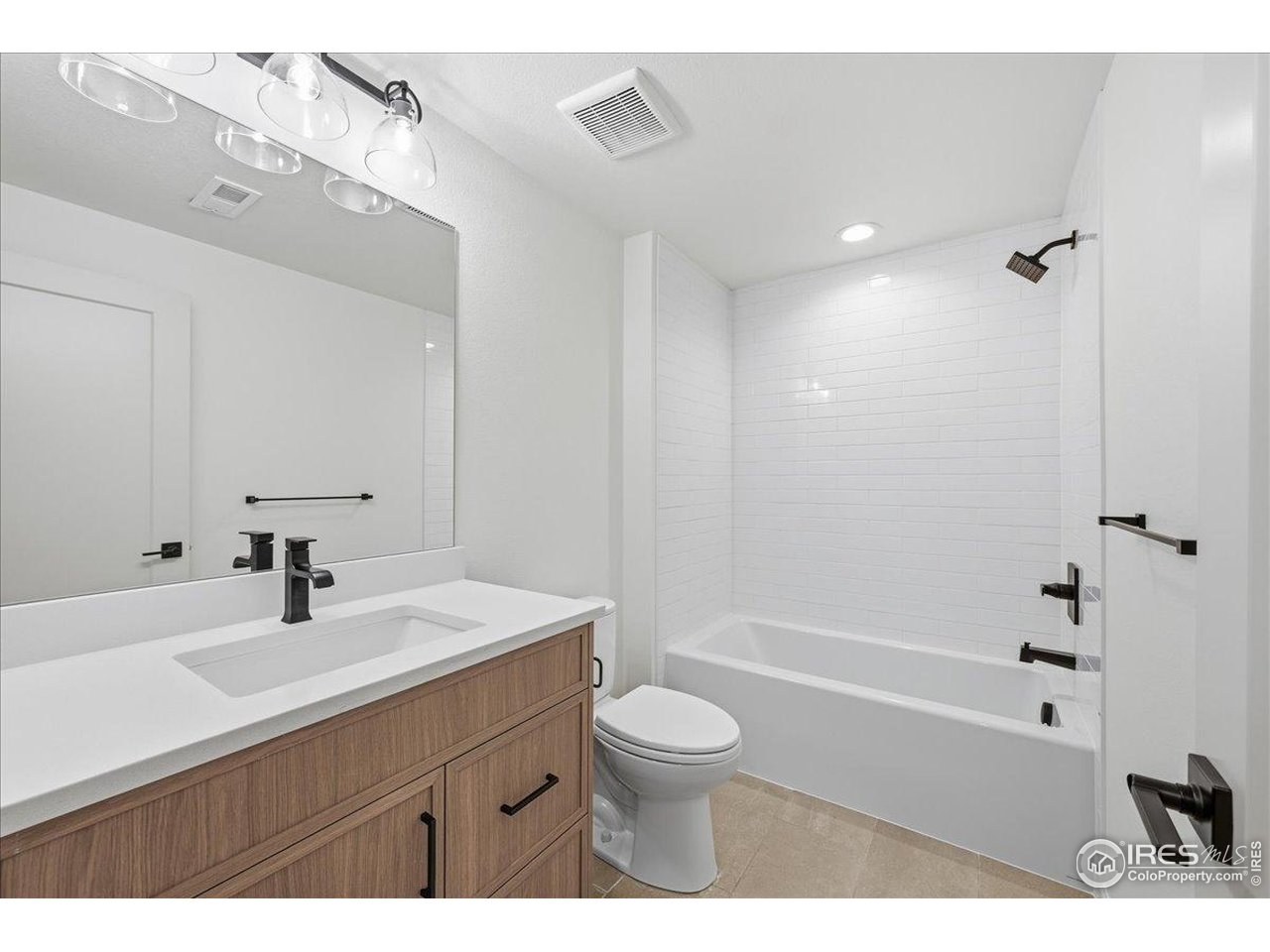 825 Doubleleaf Drive Windsor, CO 80550 - Photo 23 of 25 a bathroom with a sink a toilet and shower