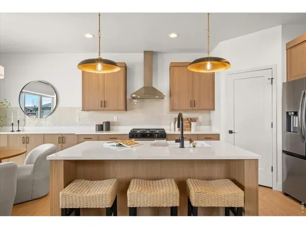 a kitchen with a table chairs sink and cabinets