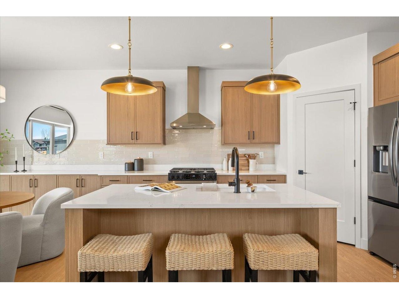 825 Doubleleaf Drive Windsor, CO 80550 - Photo 5 of 28 a kitchen with a table chairs sink and cabinets