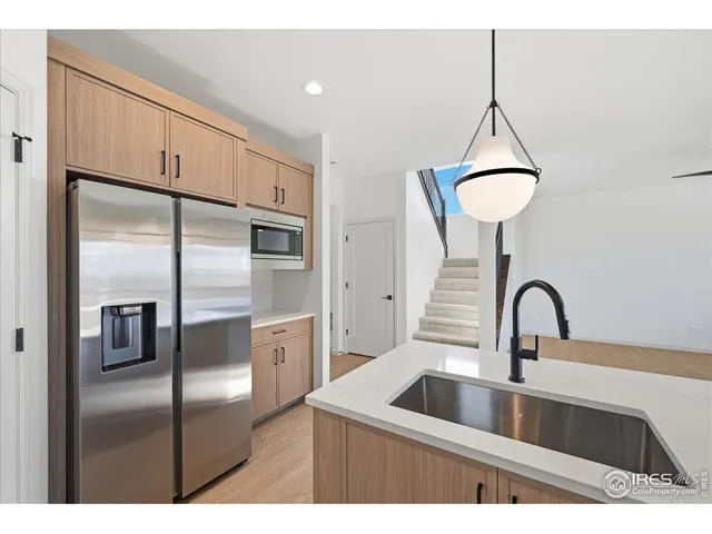a kitchen with a refrigerator and a sink