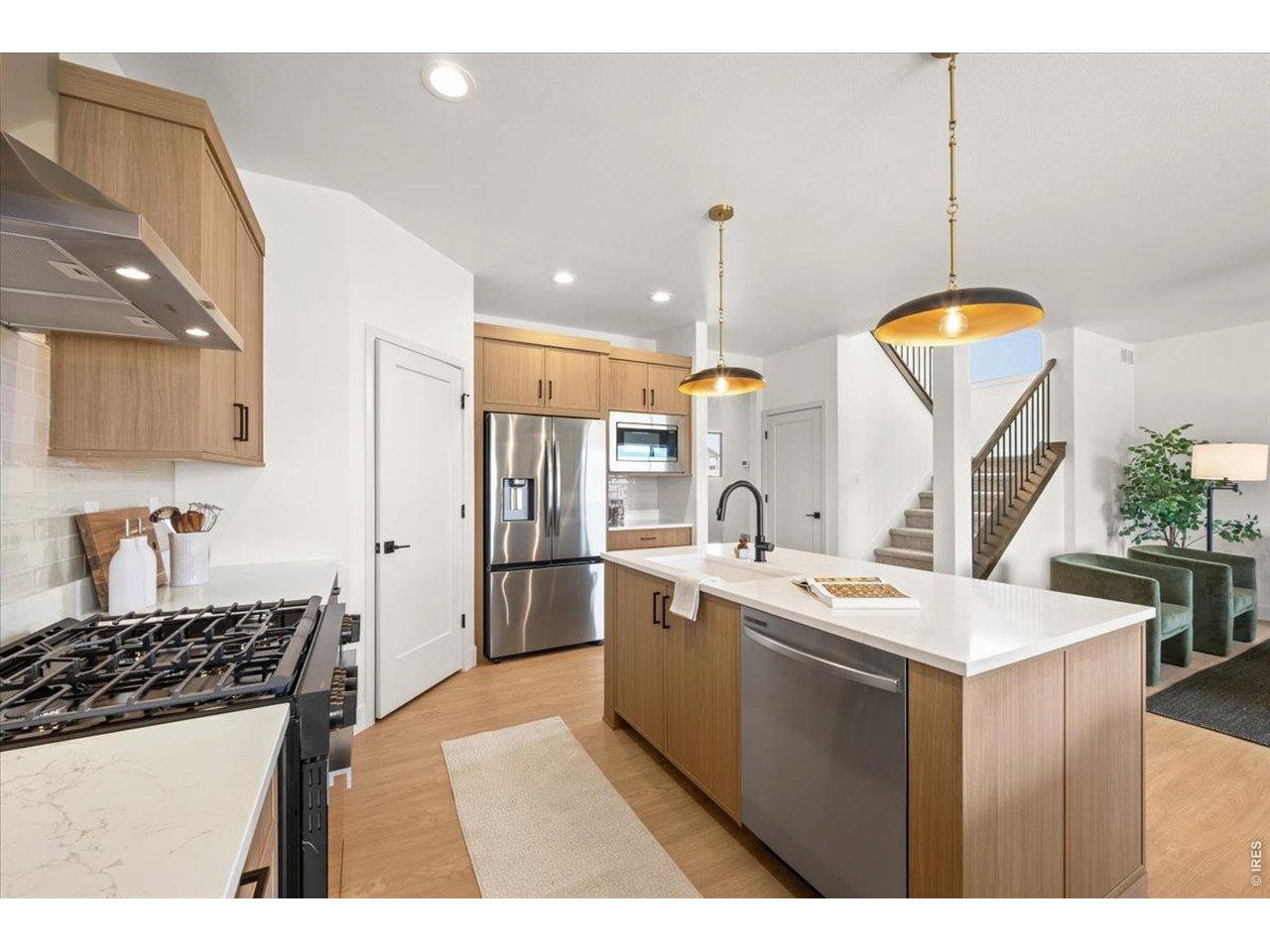 825 Doubleleaf Drive Windsor, CO 80550 - Photo 8 of 28 a kitchen with stainless steel appliances a sink a stove a refrigerator and island