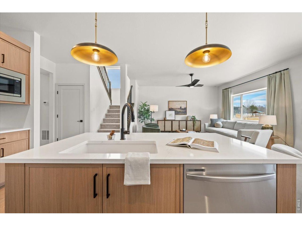 825 Doubleleaf Drive Windsor, CO 80550 - Photo 9 of 28 a kitchen with a counter space a sink and a stove
