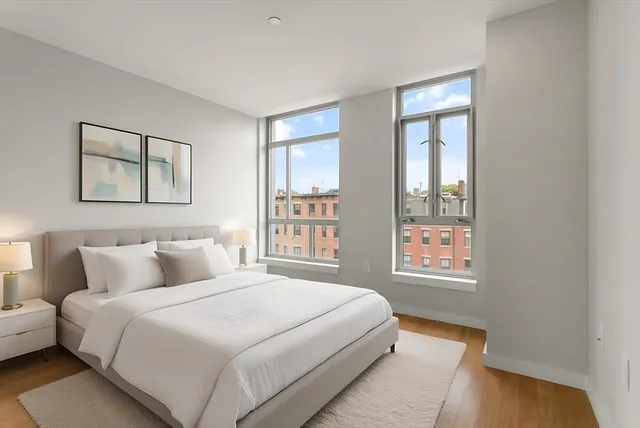 a bedroom with a bed and a window