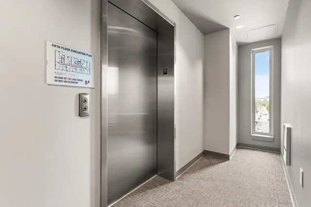 a view of a hallway with bathroom