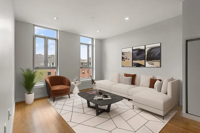 a living room with furniture rug and window