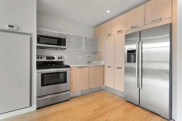 a kitchen with a refrigerator stove and microwave