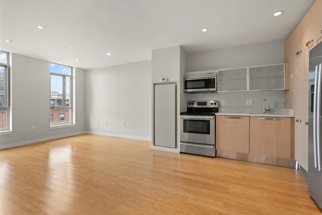 a view of a kitchen with a sink and a stove top oven