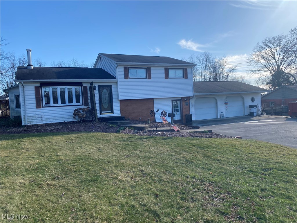 30173 Georgetown Road Salem, OH 44460 - Photo 2 of 23 Tri-level home with brick siding, aphalt driveway, a front yard, and an attached garage