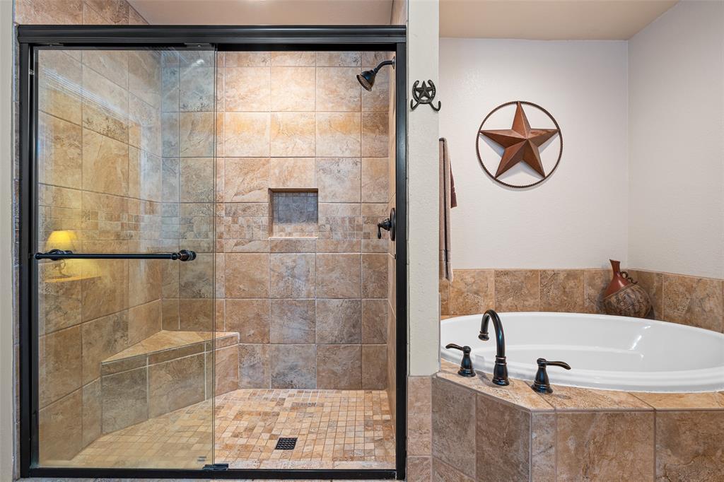 10517 Ravenswood Road Granbury, TX 76049 - Photo 20 of 35 a bathroom with a bathtub and a shower