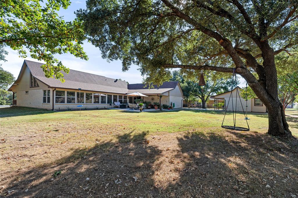10517 Ravenswood Road Granbury, TX 76049 - Photo 29 of 35 a view of house with outdoor space and swimming pool