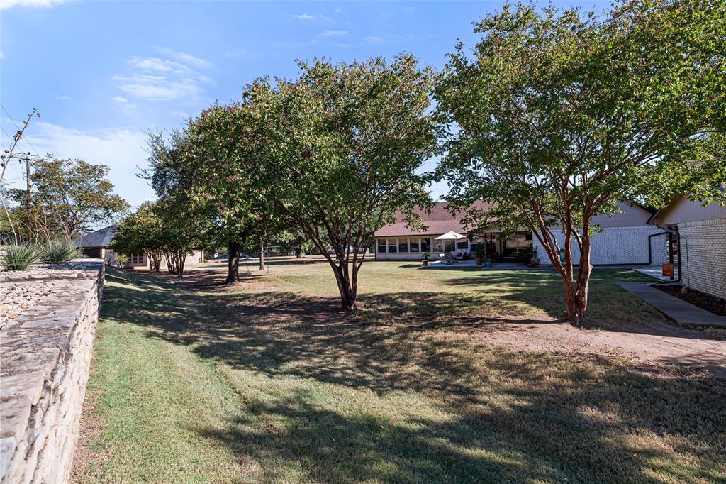 10517 Ravenswood Road Granbury, TX 76049 - Photo 30 of 35 a view of a yard with tree s