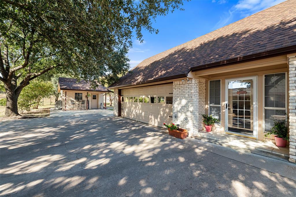 10517 Ravenswood Road Granbury, TX 76049 - Photo 32 of 35 a front view of a house with a patio