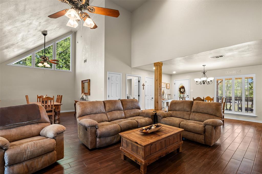 10517 Ravenswood Road Granbury, TX 76049 - Photo 6 of 35 a living room with furniture a couch and wooden floor