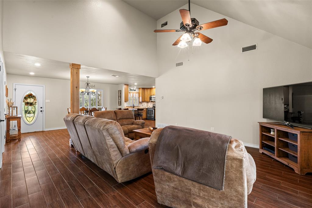 10517 Ravenswood Road Granbury, TX 76049 - Photo 7 of 35 a living room with furniture and a flat screen tv