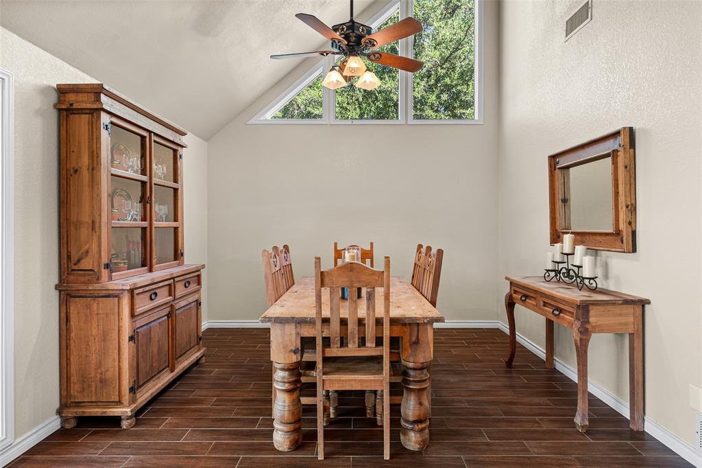 10517 Ravenswood Road Granbury, TX 76049 - Photo 8 of 35 a view of a dining room with furniture and wooden floor