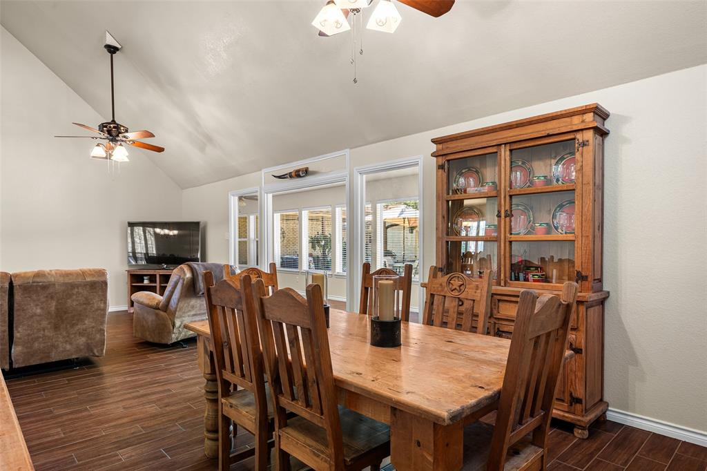 10517 Ravenswood Road Granbury, TX 76049 - Photo 9 of 35 a view of a dining room with furniture window and wooden floor