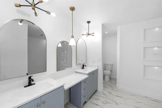 a bathroom with a double vanity sink and a mirror