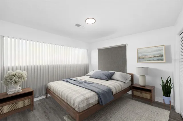 a bedroom with a bed and a painting on the wall