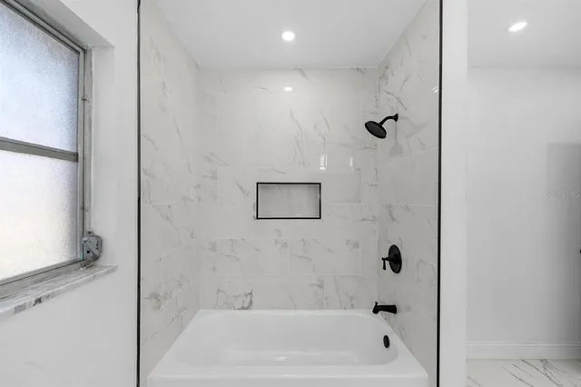 a bathroom with a bathtub and shower