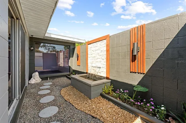 a living room with a couch and a floor to ceiling window