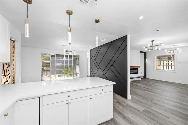a kitchen with kitchen island a sink appliances and cabinets