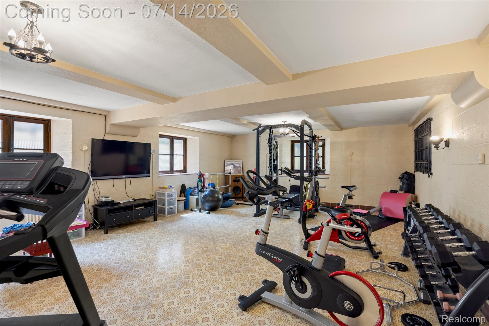 189 Cloverly Road Grosse Pointe, MI 48236 - Photo 63 of 96 Spacious room featuring patterned floor tiles, exposed ceiling beams, and multiple windows