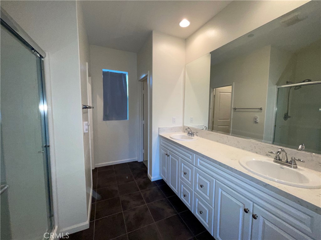22083 Propello Drive Saugus, CA 91350 - Photo 13 of 24 a bathroom with a double vanity sink and a mirror