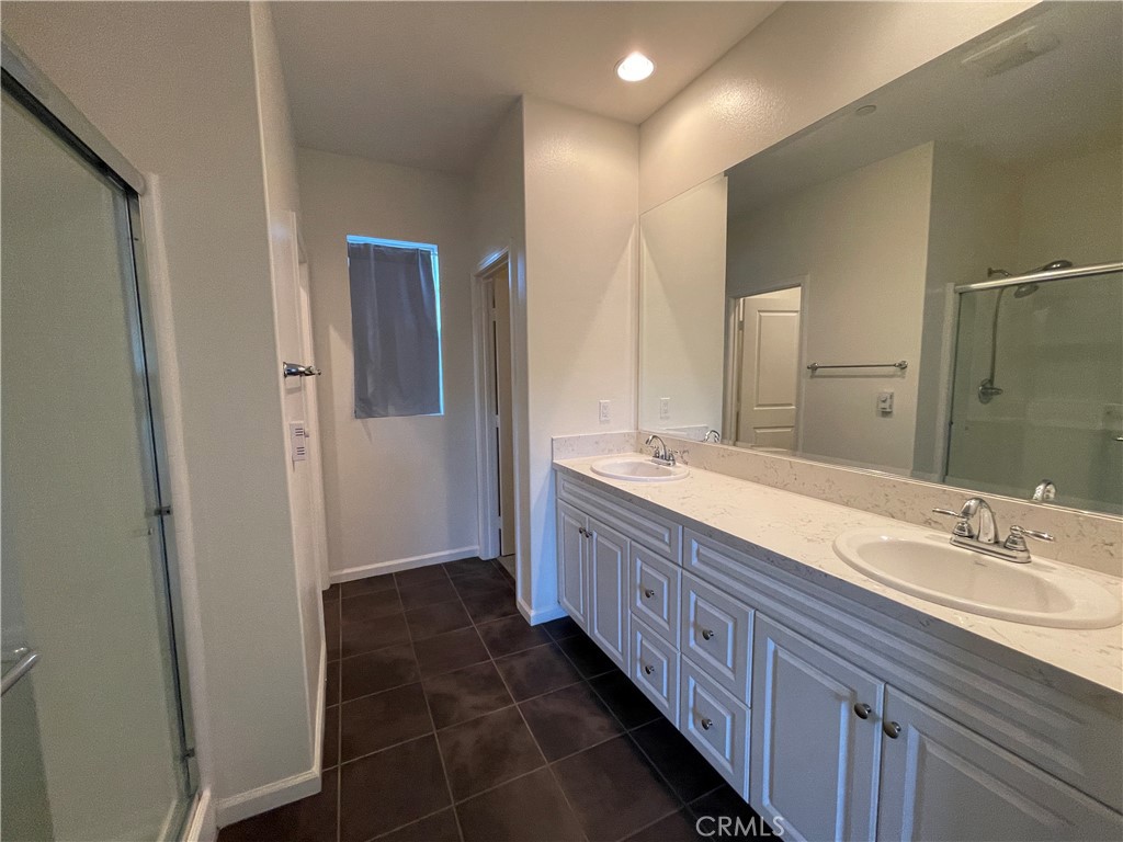 22083 Propello Drive Saugus, CA 91350 - Photo 14 of 24 a bathroom with a double vanity sink and a mirror