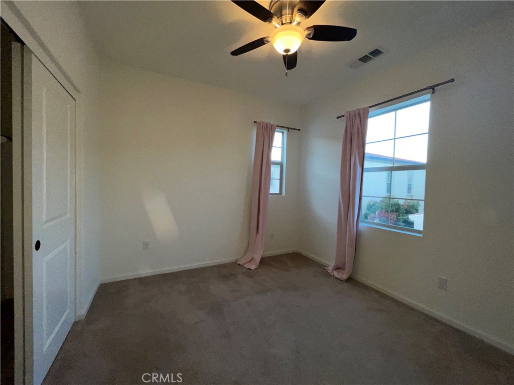 22083 Propello Drive Saugus, CA 91350 - Photo 23 of 24 an empty room with windows and fan