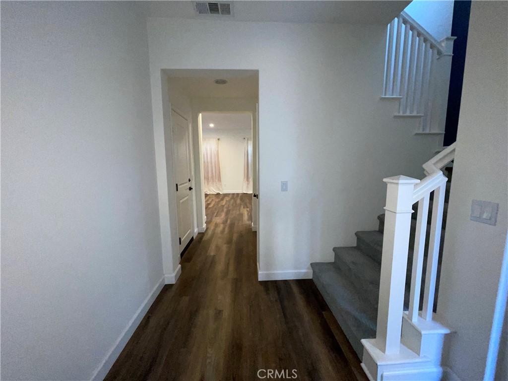 22083 Propello Drive Saugus, CA 91350 - Photo 5 of 24 a view of a hallway with wooden floor and staircase