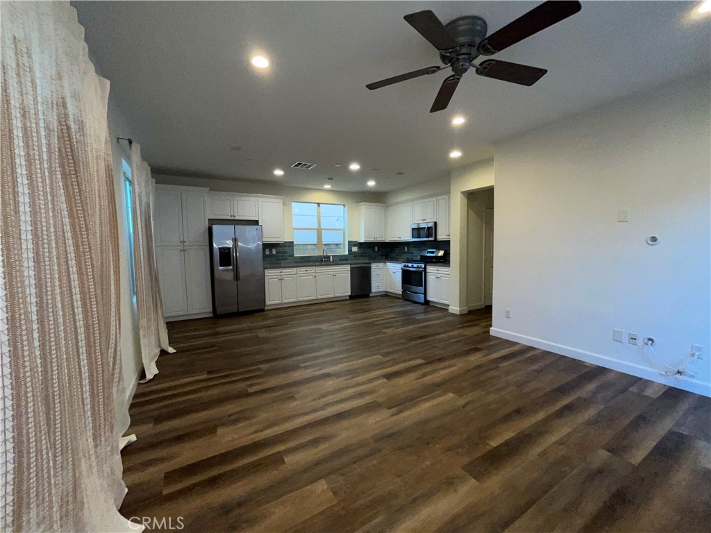 22083 Propello Drive Saugus, CA 91350 - Photo 7 of 24 a view of kitchen and empty room with wooden floor