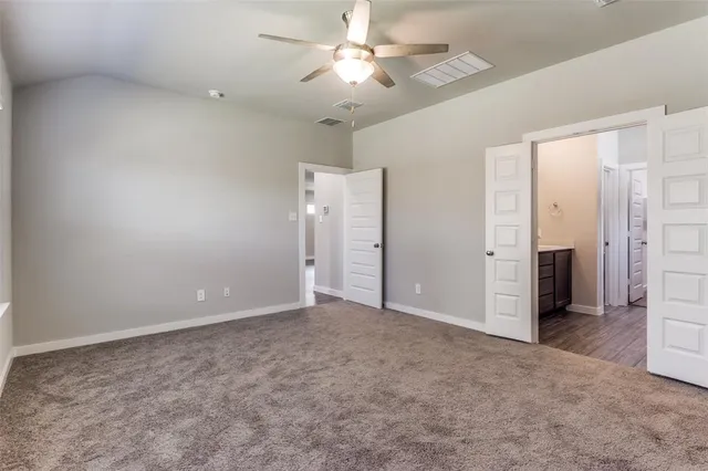 a bathroom with a bathtub shower sink vanity and toilet