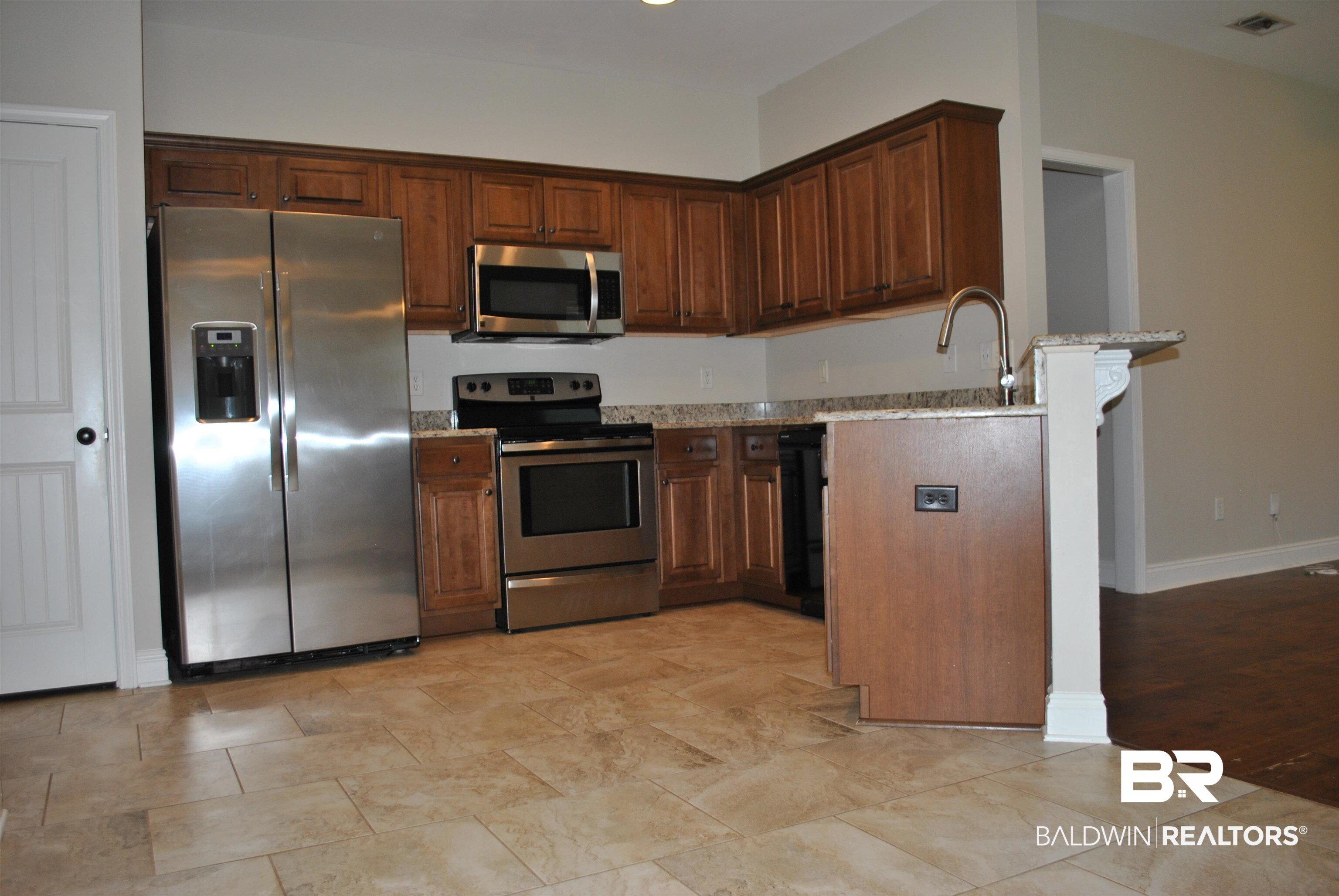 2161 Spring Grove West Mobile, AL 36695 - Photo 10 of 31 Kitchen featuring appliances with stainless steel finishes, light stone countertops, and a peninsula