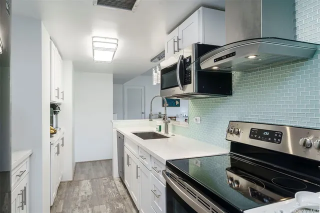 a kitchen with a stove and a sink